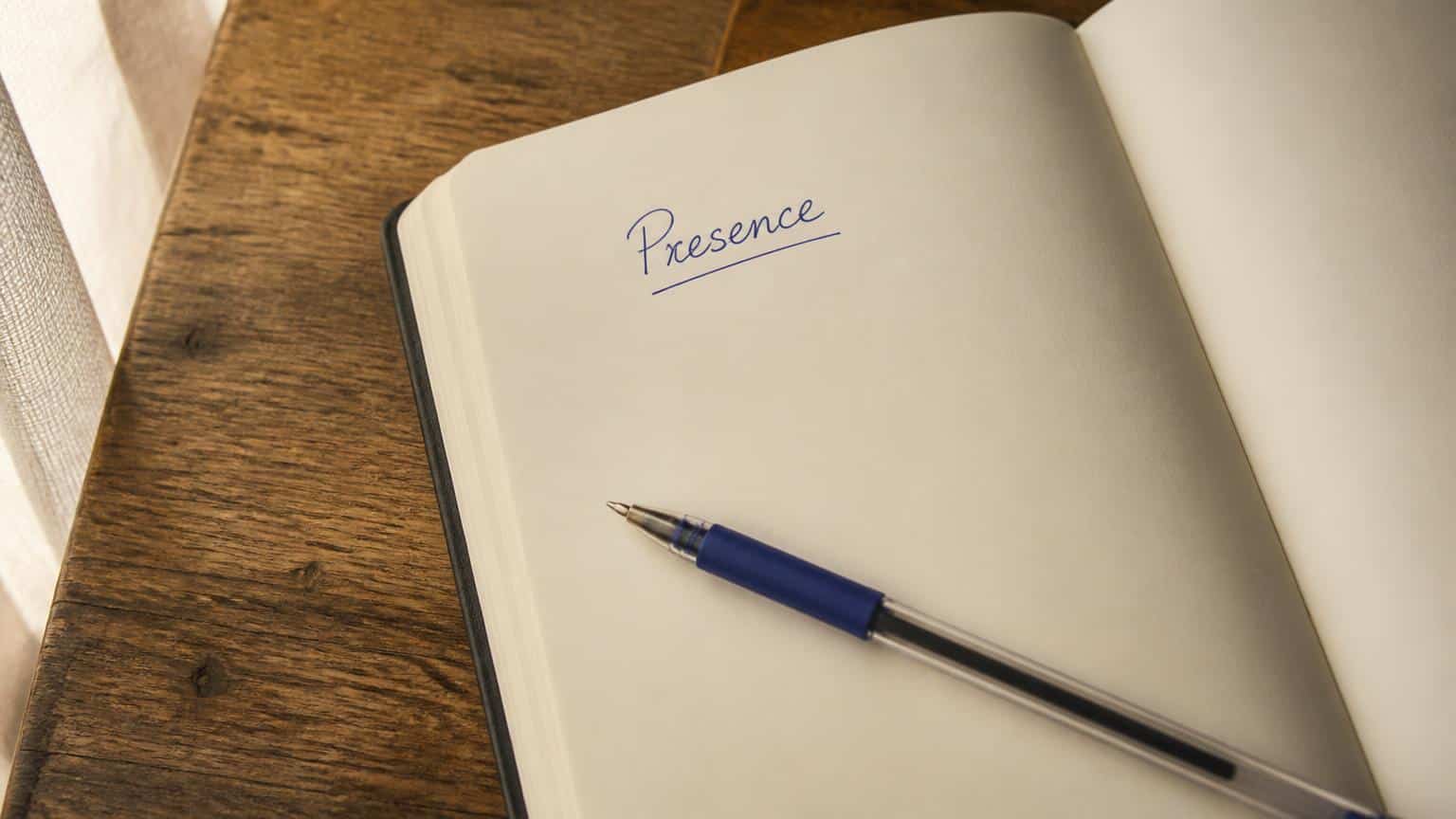 One handwritten word on an otherwise empty notebook page, symbolizing prayer beyond many words